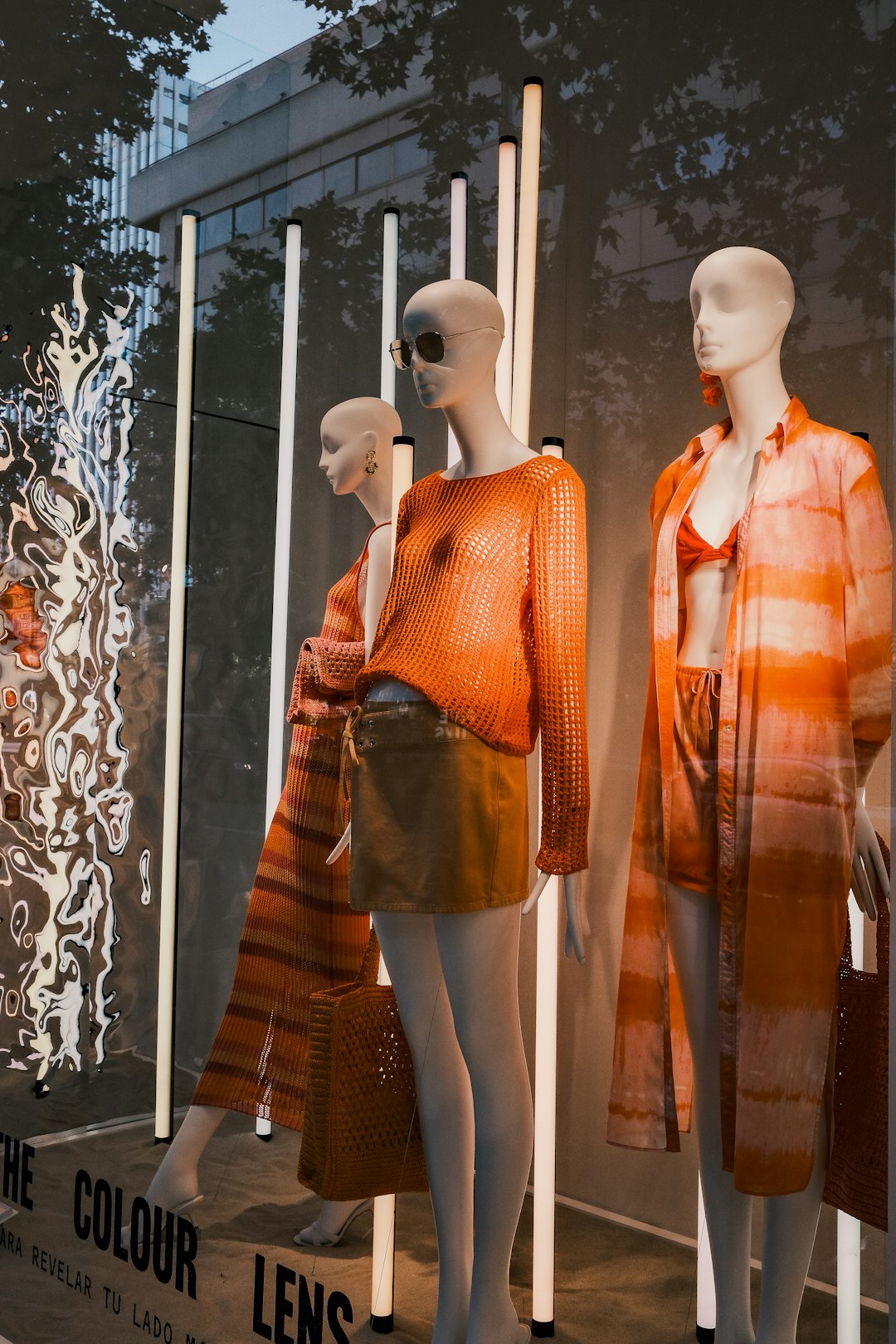 three-mannequins-dressed-in-orange-and-orange-clothing-jzu5brxdgta